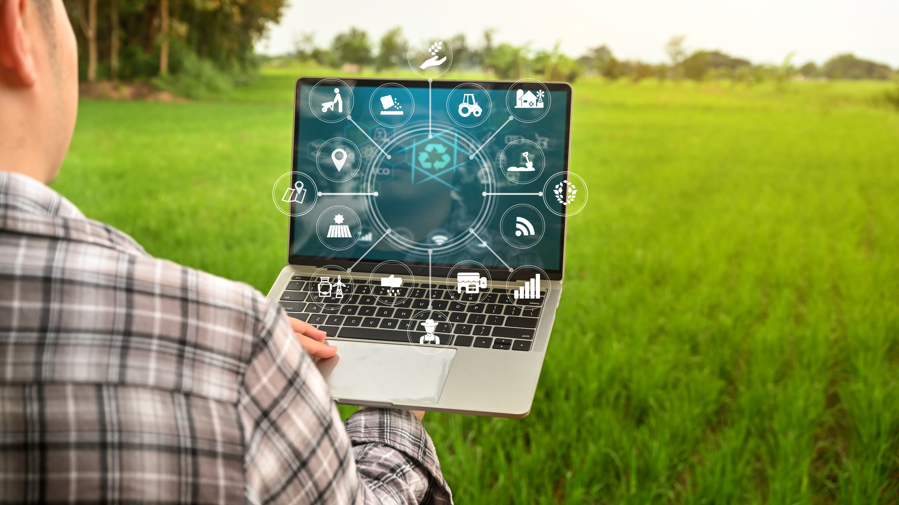 Agriculture management Innovation technology for smart farm system in laptop with smart technology concept. asian man farmer working outfield farm.